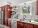 Updated kitchen featuring dark wood cabinets, marble backsplash, stainless steel appliances and sink at 2270 Emerald Dr, Jonesboro, GA 30236