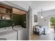 Laundry room with machines and storage that leads to sitting area with deck at 2270 Emerald Dr, Jonesboro, GA 30236