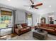 Living room showcasing wood floors, leather seating, neutral rug, and bright natural light at 2270 Emerald Dr, Jonesboro, GA 30236
