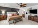 Bright bedroom with a ceiling fan, accent wall, mounted TV, and ensuite bathroom at 2270 Emerald Dr, Jonesboro, GA 30236