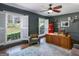 Bright office space featuring a vintage Coca-Cola fridge, ceiling fan, and hardwood floors at 2270 Emerald Dr, Jonesboro, GA 30236