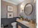 Powder room featuring wainscotting, an ornate mirror and sink, and a toilet at 2270 Emerald Dr, Jonesboro, GA 30236