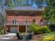Exterior view of the home's backyard, with a patio set, wooden deck, and lush greenery at 2270 Emerald Dr, Jonesboro, GA 30236
