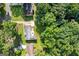Aerial view showcasing a home with a cozy backyard deck, mature trees, and manicured lawns in a peaceful neighborhood at 3210 Roseheath Ln, Lithonia, GA 30038