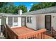Backyard brick home featuring a wooden deck at 3210 Roseheath Ln, Lithonia, GA 30038