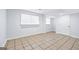 Neutral basement with tiled floors, windows, and white trim at 3210 Roseheath Ln, Lithonia, GA 30038