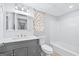 Nicely-lit bathroom with gray vanity and new shower at 3210 Roseheath Ln, Lithonia, GA 30038
