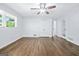 Spacious bedroom with ceiling fan, window and hardwood floors and double door closet at 3210 Roseheath Ln, Lithonia, GA 30038