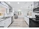 Bright kitchen featuring stainless steel appliances, granite counters, and gray-white cabinets at 3210 Roseheath Ln, Lithonia, GA 30038