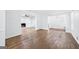Spacious living room with hardwood floors, fireplace with built-in shelving and white walls at 3210 Roseheath Ln, Lithonia, GA 30038