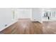Open-concept living room with hardwood floors, white walls, and ample natural light at 3210 Roseheath Ln, Lithonia, GA 30038