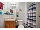Cozy bathroom featuring a single sink vanity, toilet, and shower with neutral colored walls at 8915 Tweeddale Dr, Winston, GA 30187