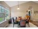 Bright dining area featuring a dark wood table, black chairs, and lots of natural light at 8915 Tweeddale Dr, Winston, GA 30187