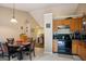 Inviting kitchen with wooden cabinetry and dining area, featuring a view to another room at 8915 Tweeddale Dr, Winston, GA 30187