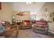Comfortable living room with plush, oversized seating and an open view into the dining area at 8915 Tweeddale Dr, Winston, GA 30187