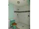 Bathroom featuring a vintage style green toilet and white marble tiled shower at 1306 Stonemont Rd, Auburn, GA 30011