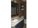 Bathroom with vanity, mirror and cabinet. Toilet on side of vanity at 1306 Stonemont Rd, Auburn, GA 30011