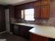 Kitchen features wood cabinets and tile backsplash at 1306 Stonemont Rd, Auburn, GA 30011