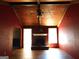 Living room with beamed ceiling, ceiling fan, fireplace, and wooden floors at 1306 Stonemont Rd, Auburn, GA 30011