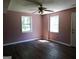 Room with hardwood floors, pink walls, and a ceiling fan at 1306 Stonemont Rd, Auburn, GA 30011