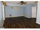 Room with dark hardwood floors, light blue walls, and a ceiling fan at 1306 Stonemont Rd, Auburn, GA 30011