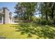 Large backyard featuring a patio, lush lawn, privacy fence and mature trees at 2303 Sharon Se Ct, Conyers, GA 30013
