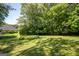 Expansive backyard with mature trees and a well-maintained lawn at 2303 Sharon Se Ct, Conyers, GA 30013