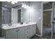 Bathroom featuring a double sink vanity with white cabinets and gray wood-look flooring at 2303 Sharon Se Ct, Conyers, GA 30013