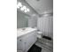 Bathroom featuring a white vanity, toilet, and a shower with a gray and white curtain at 2303 Sharon Se Ct, Conyers, GA 30013