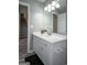 Modern bathroom featuring a white vanity, a large mirror, and stylish gray flooring at 2303 Sharon Se Ct, Conyers, GA 30013