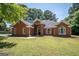 Charming brick home featuring a well-manicured lawn and inviting front entrance at 2303 Sharon Se Ct, Conyers, GA 30013