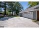 Spacious two-car garage with a concrete driveway and lush greenery at 2303 Sharon Se Ct, Conyers, GA 30013