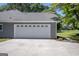 Attached two-car garage featuring a clean white door and grey painted walls at 2303 Sharon Se Ct, Conyers, GA 30013