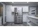 White cabinets and stainless steel refrigerator add a modern touch to this kitchen at 2303 Sharon Se Ct, Conyers, GA 30013