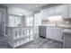 Bright kitchen with white cabinetry, a center island, and stainless steel appliances at 2303 Sharon Se Ct, Conyers, GA 30013