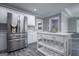Open kitchen layout with stainless steel refrigerator, island, and sleek gray flooring at 2303 Sharon Se Ct, Conyers, GA 30013