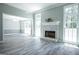 Bright living room featuring fireplace, large windows, and new hardwood floors at 2303 Sharon Se Ct, Conyers, GA 30013