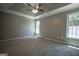 Spacious main bedroom with trey ceiling and windows providing natural light at 2303 Sharon Se Ct, Conyers, GA 30013