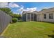 Backyard view featuring a screened-in porch, a wooden privacy fence, and a patch of green lawn at 395 Sylvan Loop, Fayetteville, GA 30214