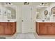 Bathroom featuring double vanity with marble countertops and wood cabinets, offering ample space and storage at 395 Sylvan Loop, Fayetteville, GA 30214