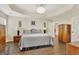 Spacious bedroom with hardwood floors, tray ceilings, and a large bed for comfort and relaxation at 395 Sylvan Loop, Fayetteville, GA 30214