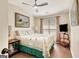 Comfortable bedroom featuring a ceiling fan, wood flooring, and natural light from the window at 395 Sylvan Loop, Fayetteville, GA 30214
