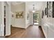 Elegant entryway with hardwood flooring, decorative wall paneling, and stylish artwork at 395 Sylvan Loop, Fayetteville, GA 30214