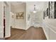 Bright entryway with wood floors, decorative wall panels, and elegant light fixtures at 395 Sylvan Loop, Fayetteville, GA 30214