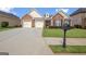 Beautifully maintained brick home featuring a lush green lawn and a convenient mailbox at 395 Sylvan Loop, Fayetteville, GA 30214