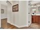 Inviting hallway leading to a bathroom with a wooden vanity and tiled floor at 395 Sylvan Loop, Fayetteville, GA 30214