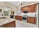Spacious kitchen featuring stainless steel appliances and views of the breakfast area and modern countertops at 395 Sylvan Loop, Fayetteville, GA 30214