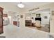 Open living space showcases tile flooring, seamless transition to hardwood, and a view of the kitchen and living room at 395 Sylvan Loop, Fayetteville, GA 30214