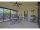 Covered patio featuring a fan and cozy seating, perfect for relaxing and entertaining outdoors at 395 Sylvan Loop, Fayetteville, GA 30214