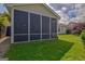 Exterior view of a screened-in porch attached to a home, with a well-kept green lawn at 395 Sylvan Loop, Fayetteville, GA 30214